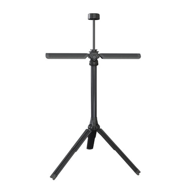 Wobig Portable Tactical Gear Stand with a sleek black finish, featuring a central pole and a horizontal crossbar, set up on a grassy lawn with a backdrop of fallen autumn leaves